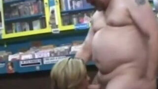 Woman randomly sucks a dirty video store clerk