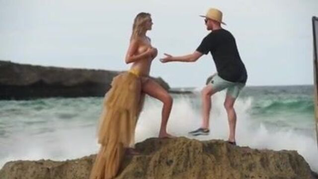 Kate Upton on the beach, washed of rock while topless